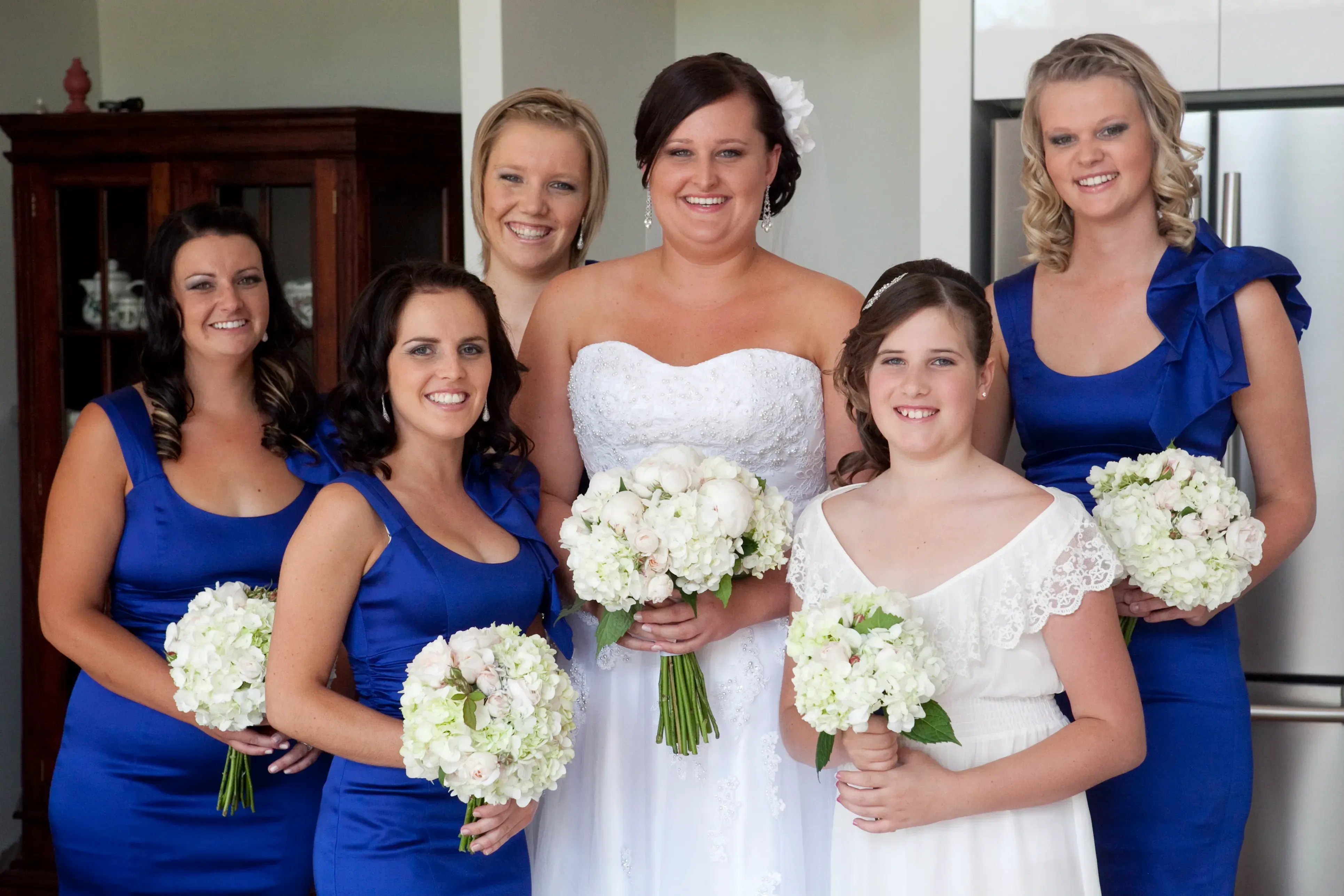A bride surrounded by her bridal party, everyone styled by Amanda Frost