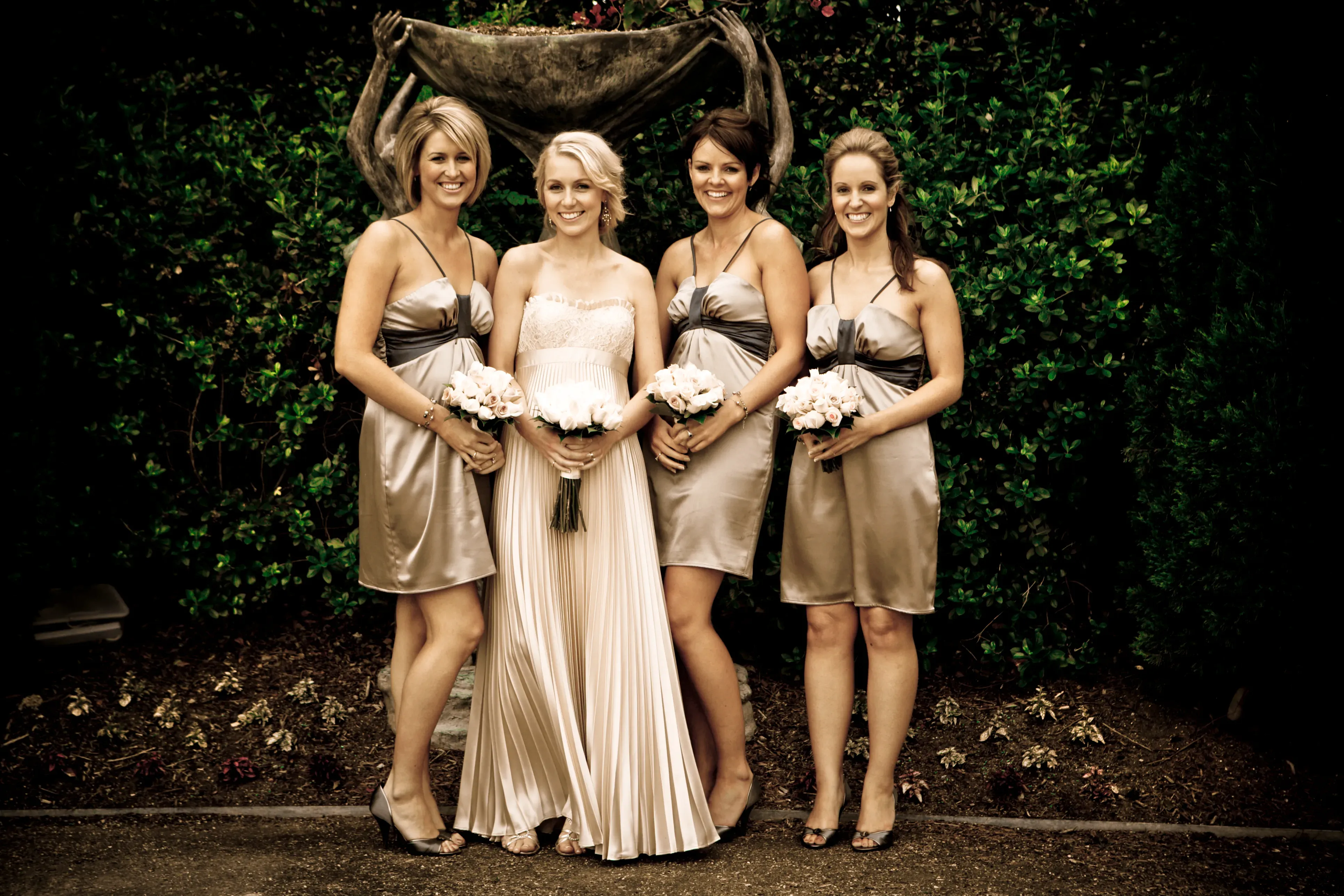 A Bellus bride and her bridesmaids in gold satin gowns, styled for a Hunter Valley wedding