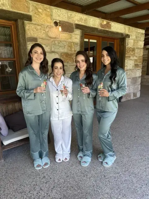 Bride and her bridesmaids in matching pyjamas before hair and makeup begins