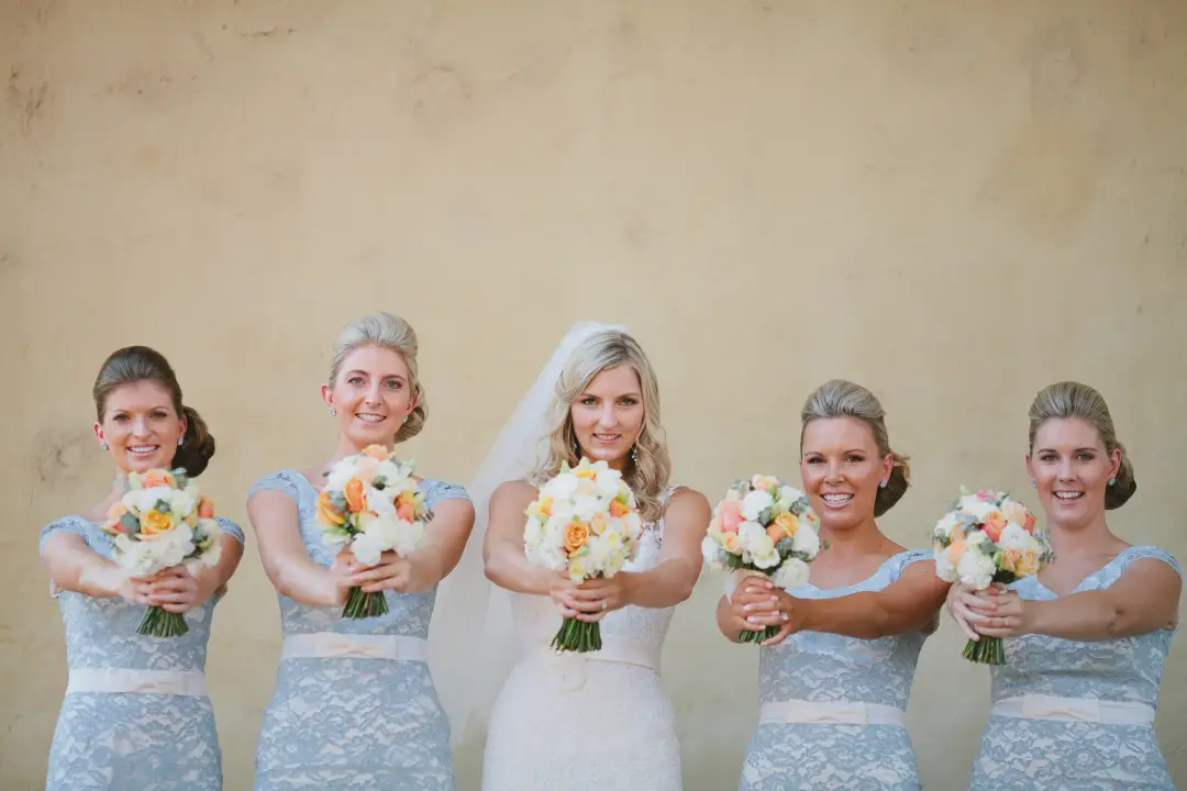 Bride and four bridesmaids in pale blue lace, every one styled with her hair pinned back