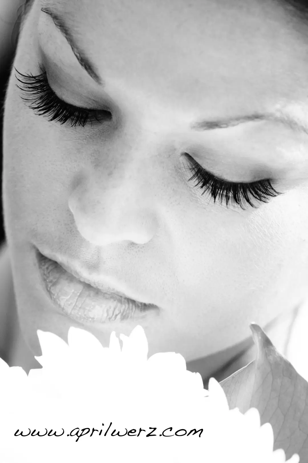 Close view of false lashes and softly shaded eye makeup on a bride