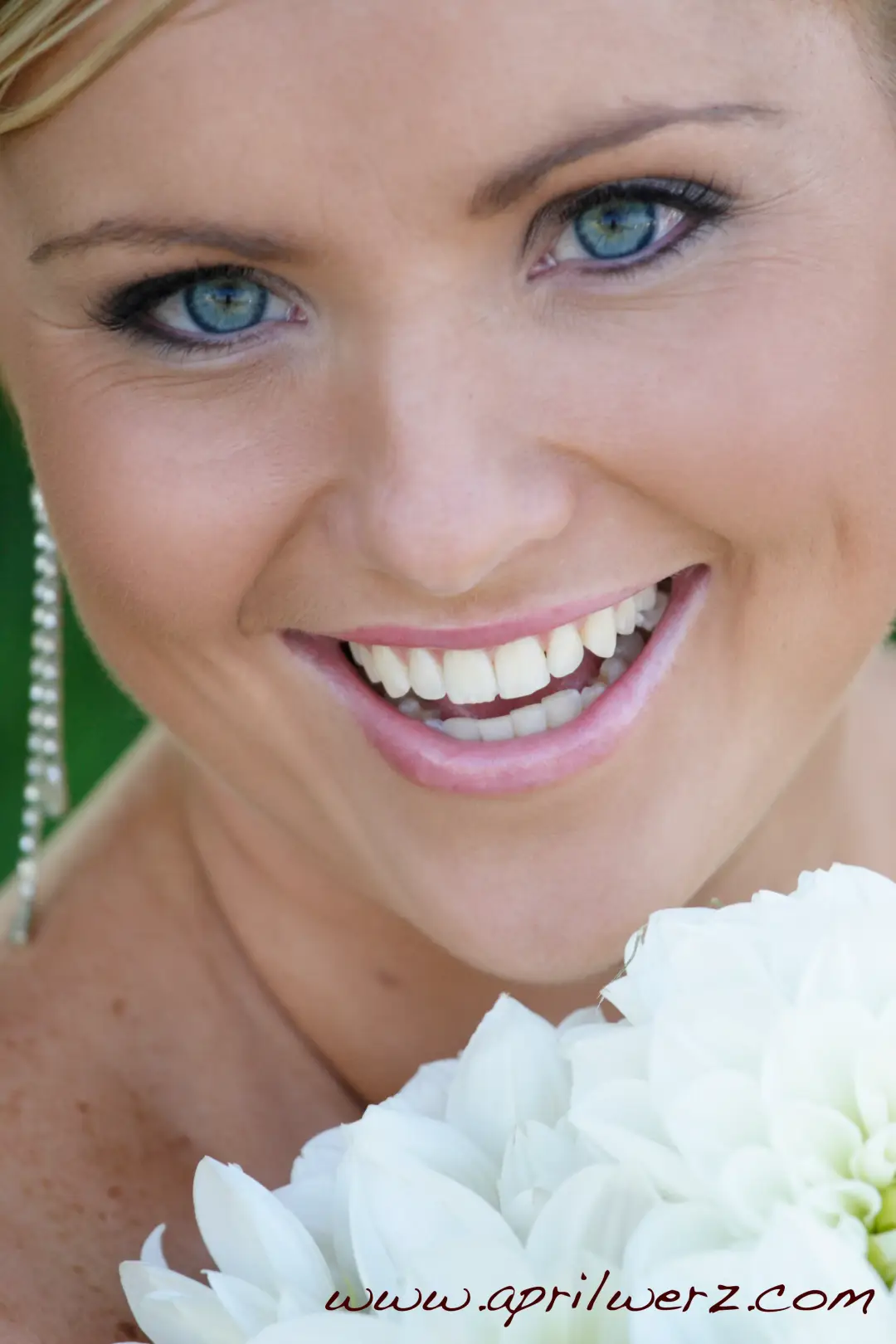 Close portrait of natural bridal makeup with a soft liner and glossy lip
