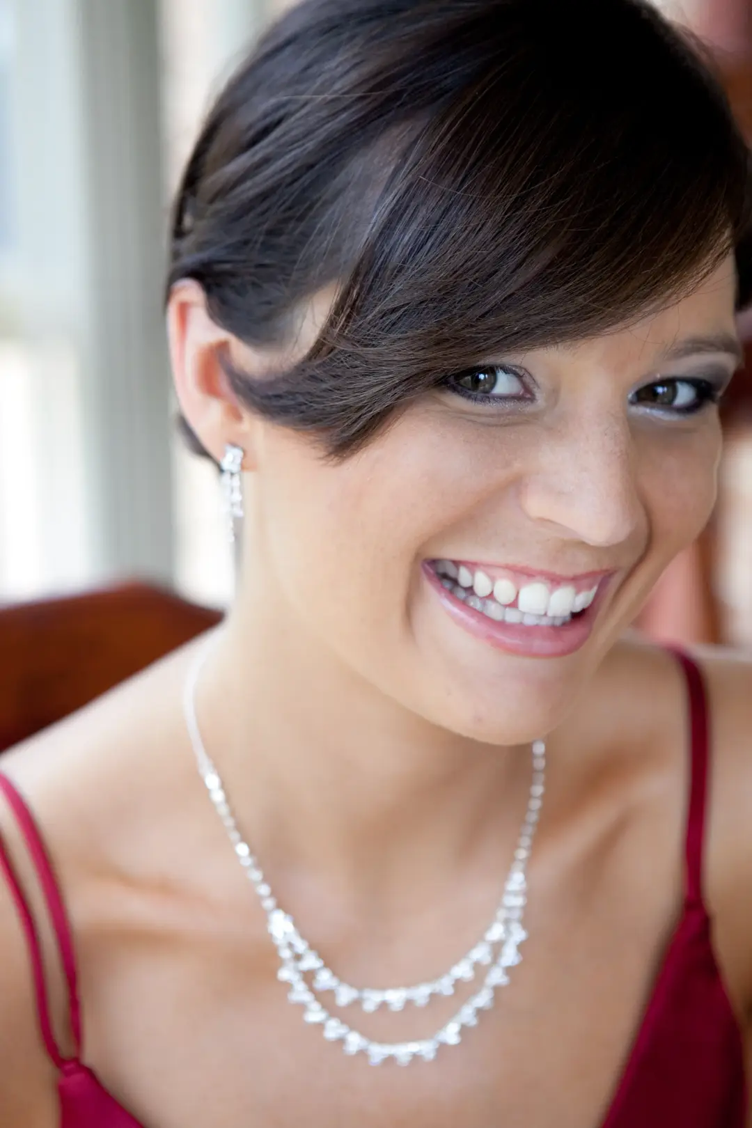 Guest with a dark pinned style swept across the brow, wearing a soft neutral eye