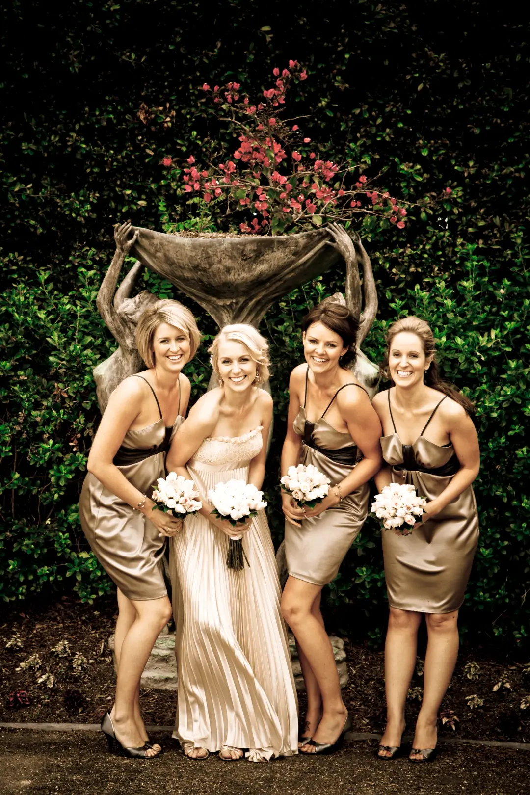 Bride and four bridesmaids in champagne satin, every one styled with her hair pinned up