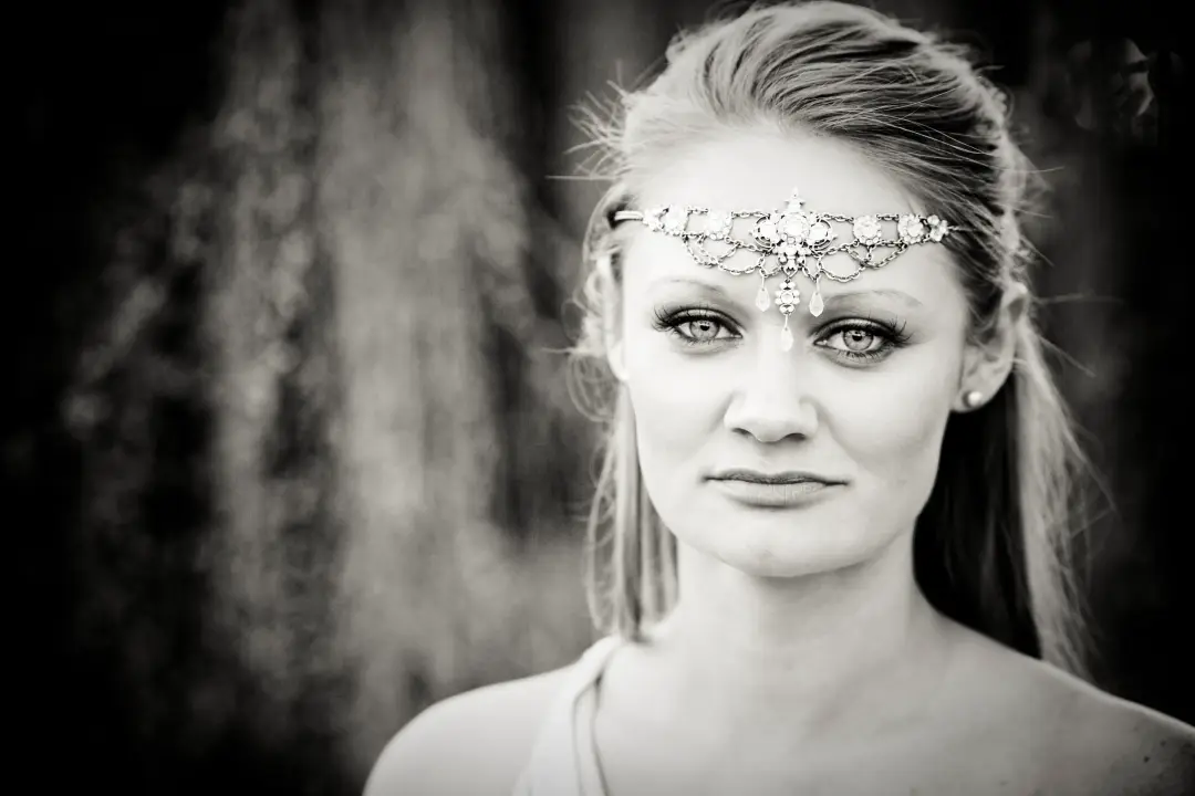 Bride in a beaded browband with her hair pulled back, wearing defined eye makeup