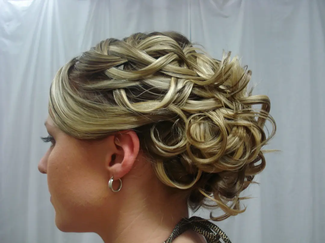 Side view of a full curled upstyle built from ringlets on highlighted blonde hair