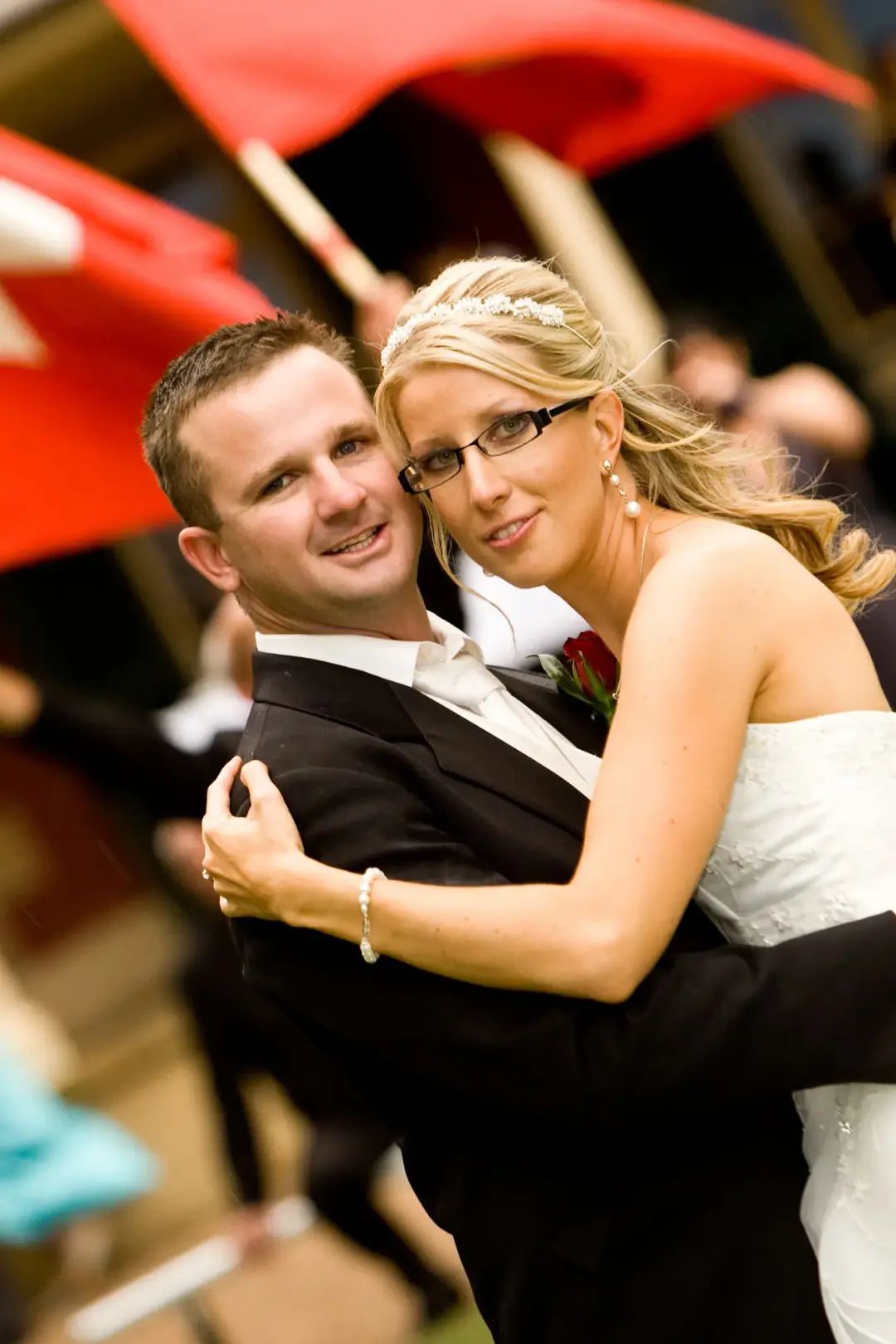Bride and groom on the dance floor, her blonde hair pinned back with a jewelled band