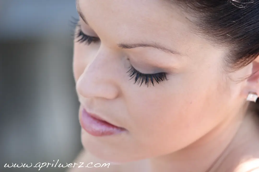 Close view of a full false lash and softly shaded lid on a bride with dark hair