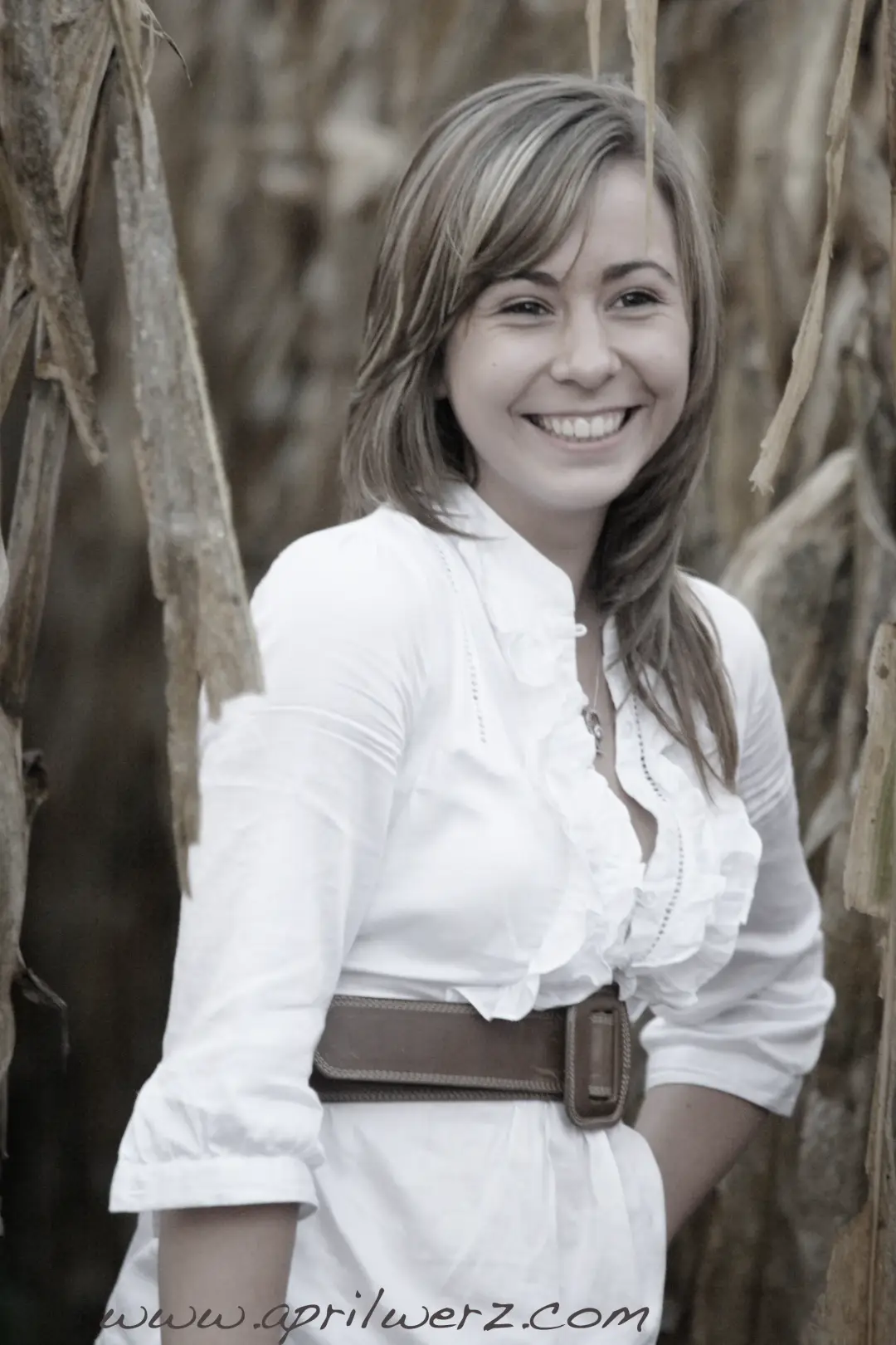 Guest photographed in a cornfield, her hair styled long and smooth over one shoulder
