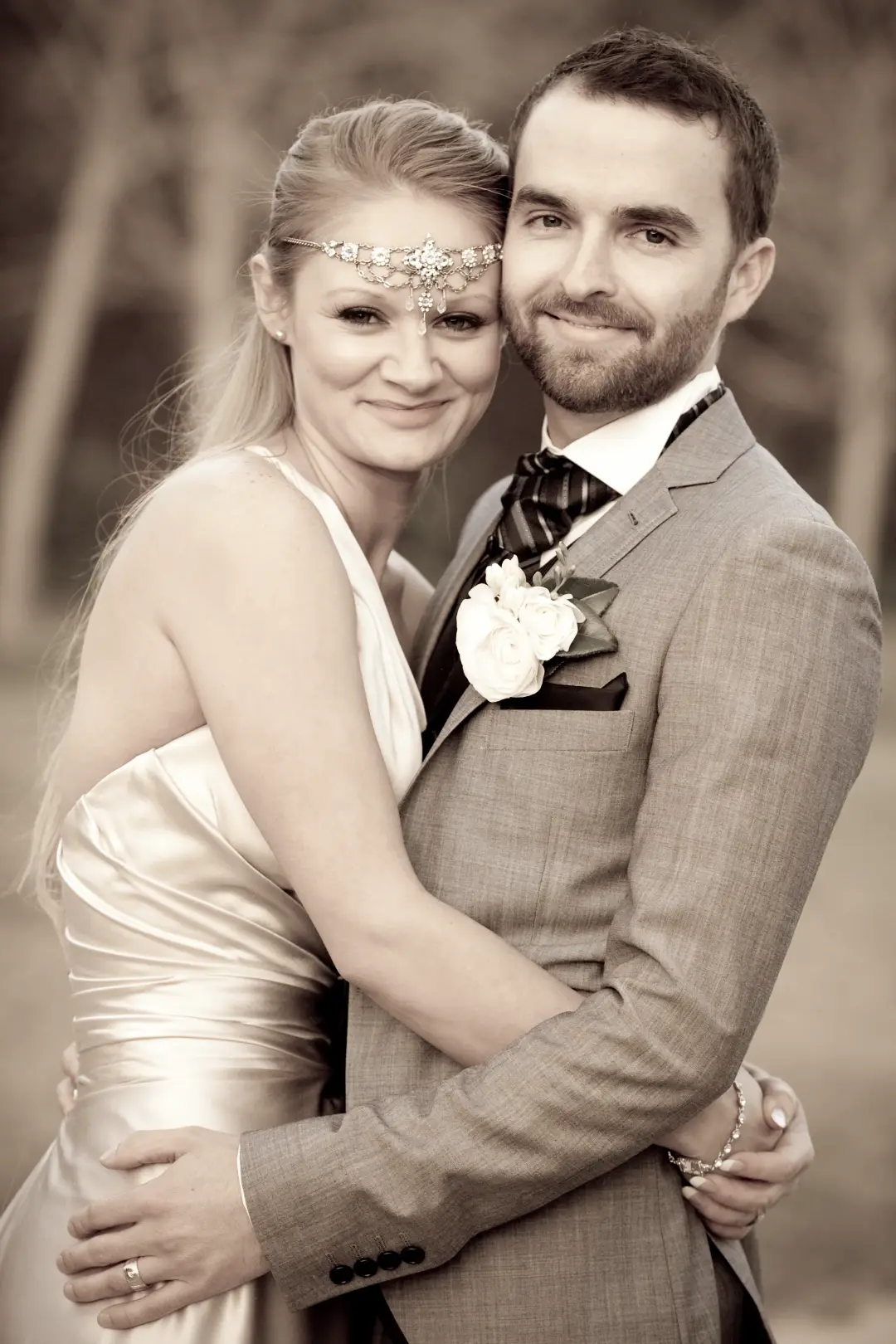 Bride and groom in the sun, the bride wearing a beaded browband with her long hair loose