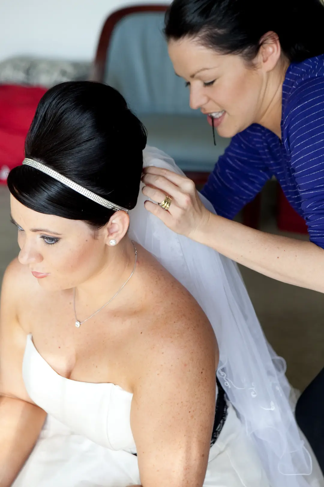 Veil pinned into a bride's dark beehive style finished with a diamante headband