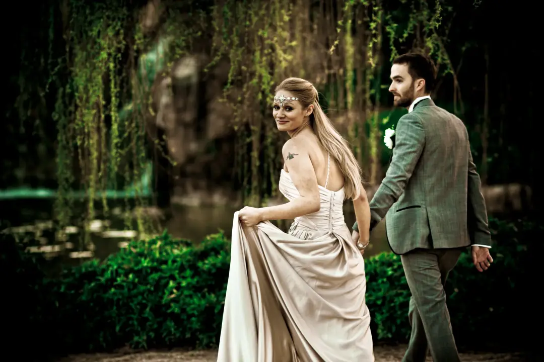 Couple eloping in a fern garden, the bride's long hair worn loose with a beaded browband