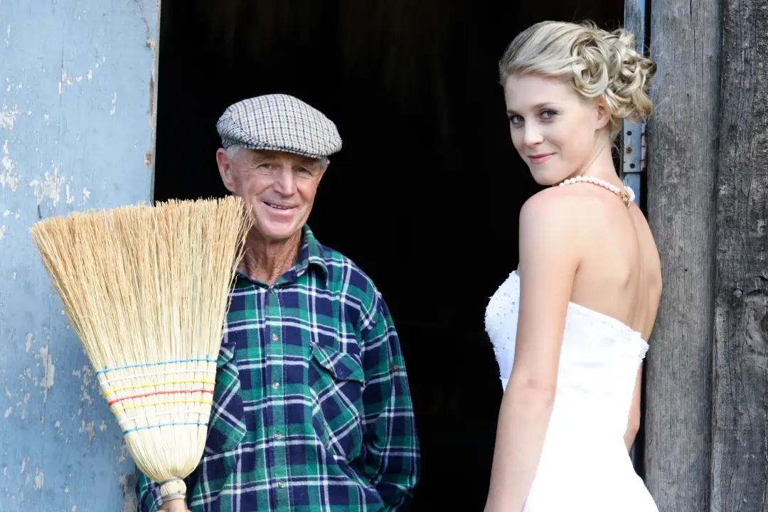 Guest in a barn doorway with her blonde hair pinned into a curled updo