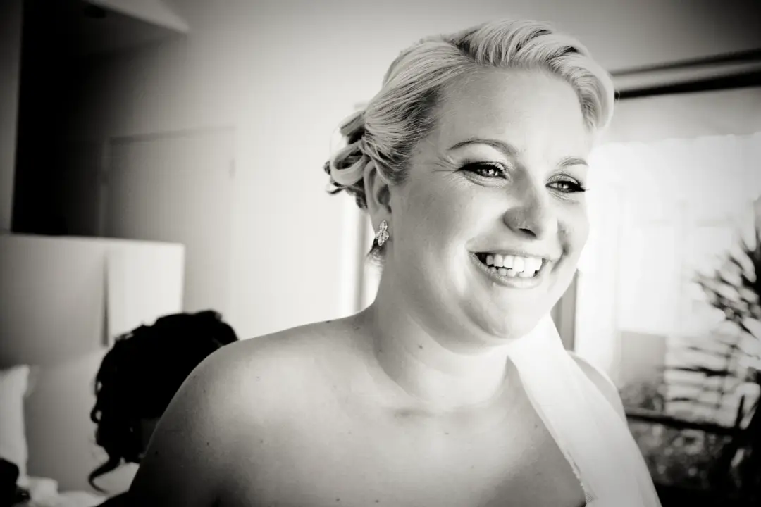 Event portrait of a guest in a soft pinned up style, wearing polished formal makeup