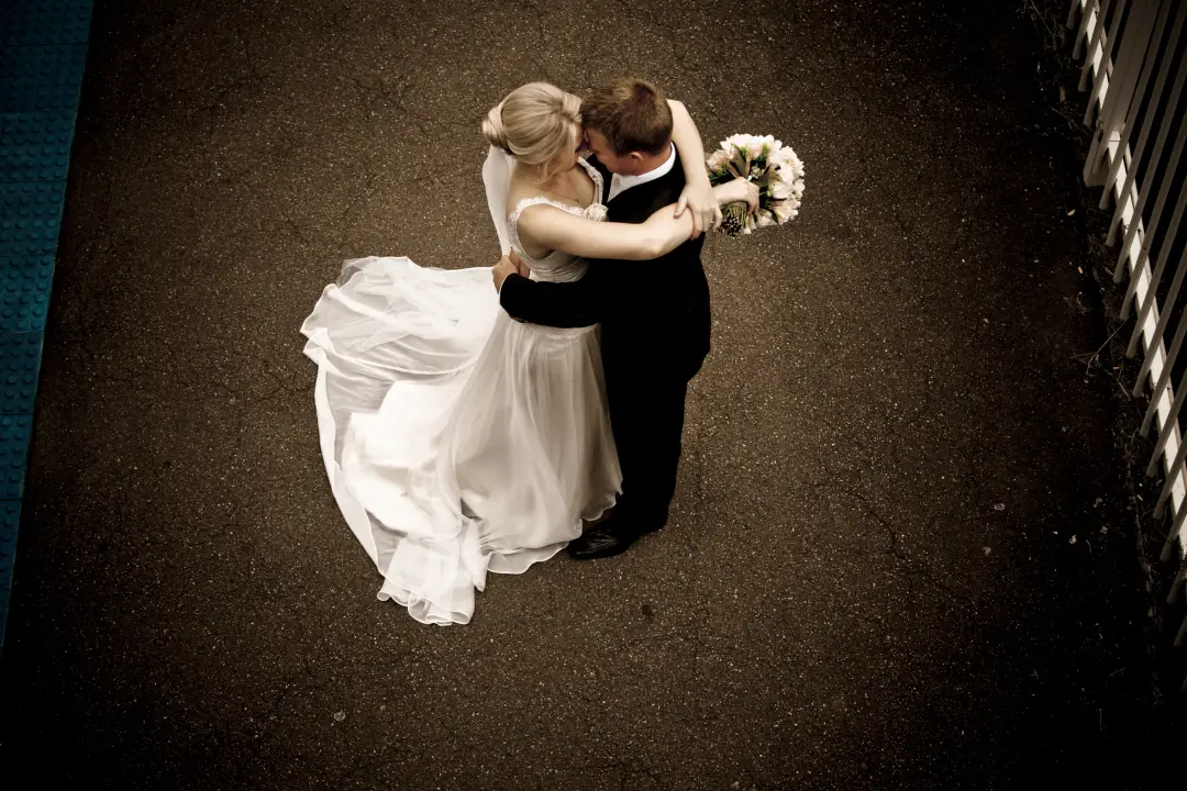 Bride and groom dancing photographed from above, the bride's blonde hair pinned into an updo