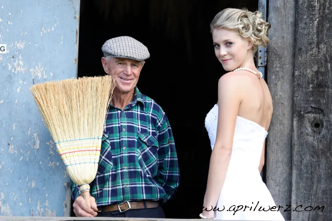 Guest in a barn doorway, her blonde hair curled and pinned into an updo