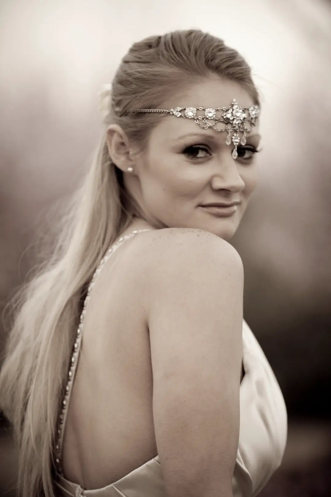Guest with long blonde hair worn straight and loose, wearing a jewelled forehead chain