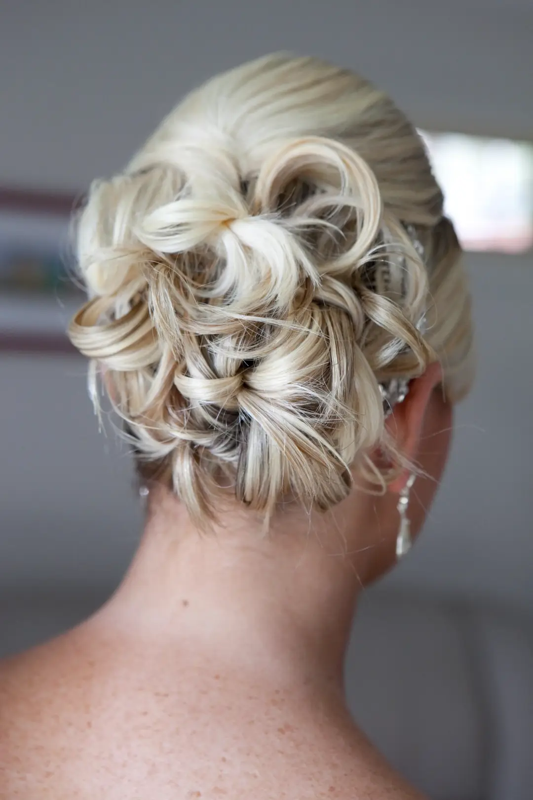 Back view of a blonde upstyle built from twisted and pinned curls