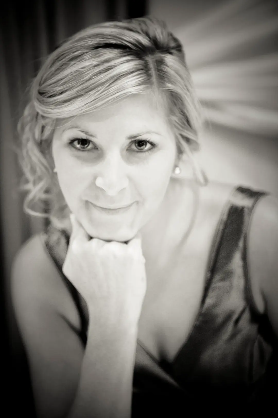 Guest with her blonde hair pinned back into a soft twist, wearing natural evening makeup