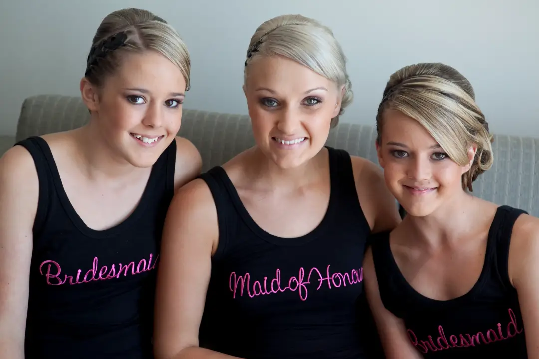 Bridesmaids and the maid of honour in matching singlets, hair and makeup finished before dressing