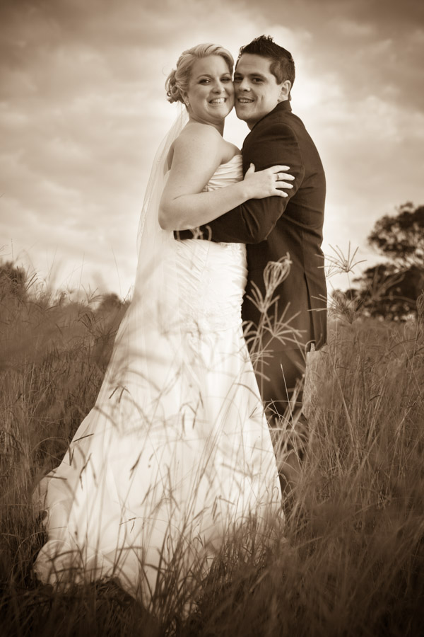 bride and groom hugging bold bridal makeup